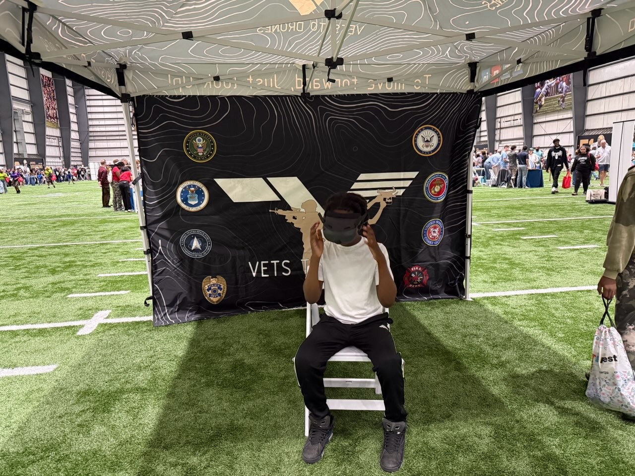 Young drone pilot training with FPV goggles at a V2D STEM event