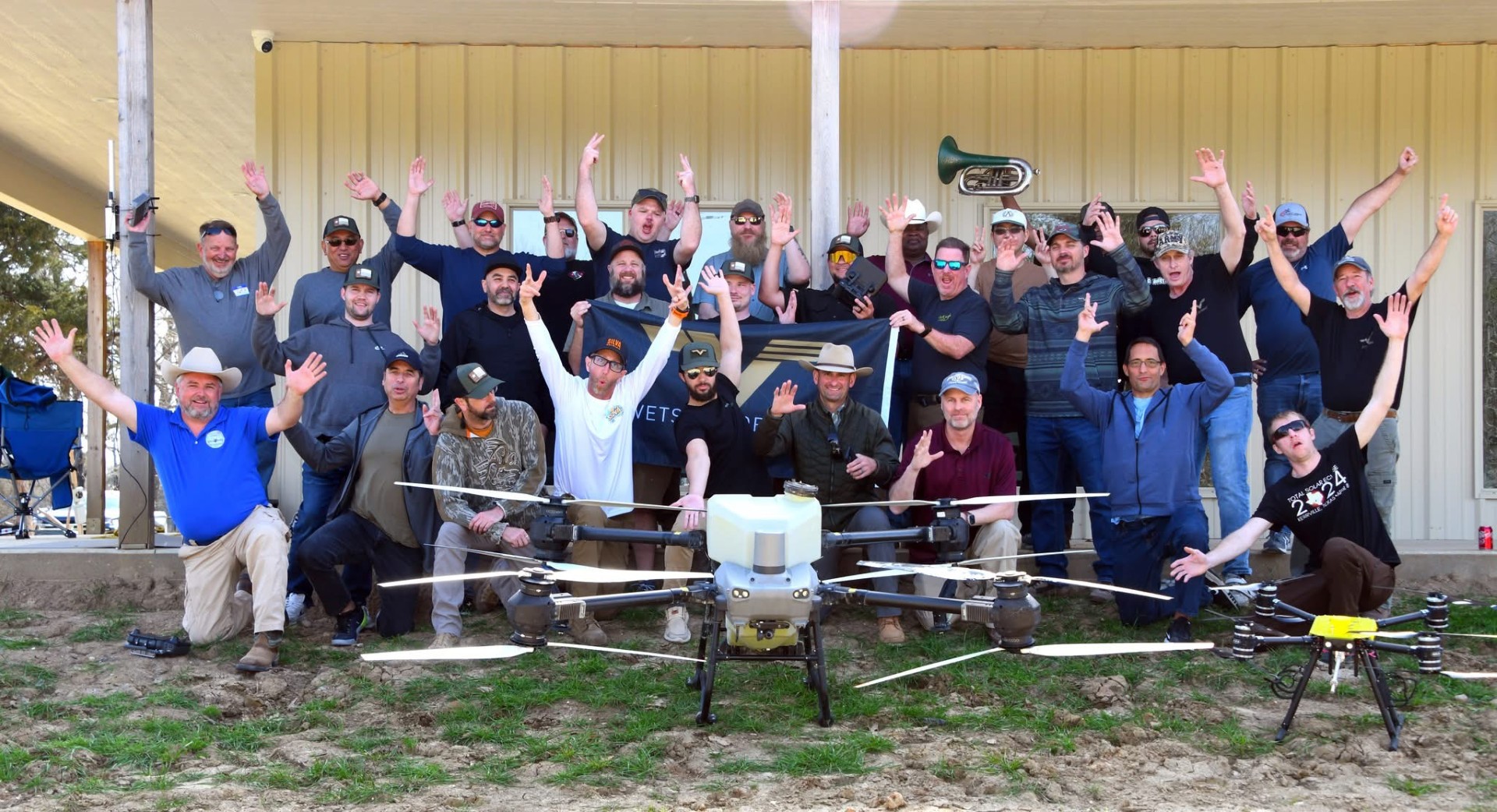 V2D members at a training event with agricultural drone